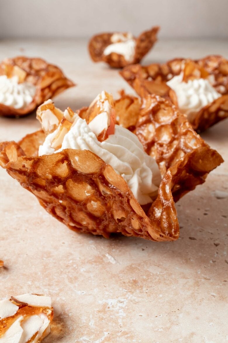 side view of brandy snap basket filled with mascarpone whipped cream