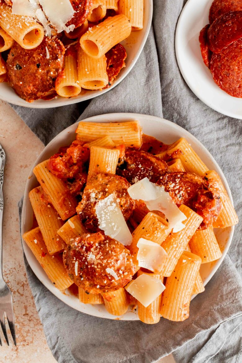 two plates with rigatoni pasta and creamy chorizo sauce