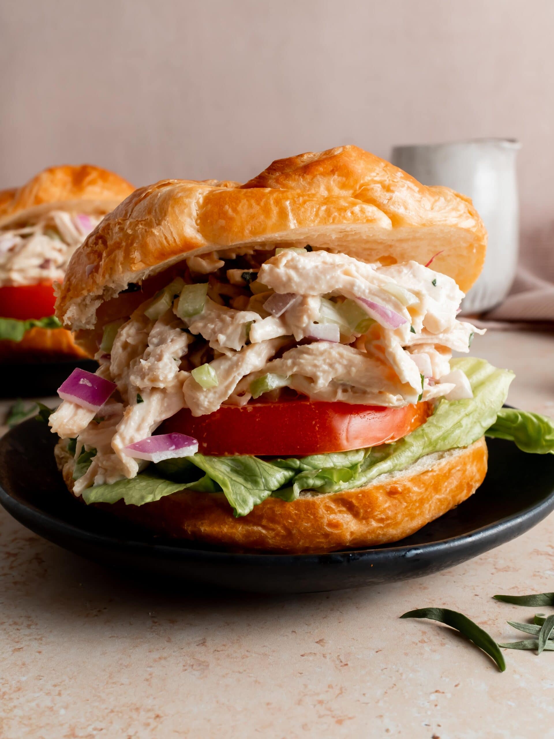 croissant sandwich with chicken salad, lettuce and tomato