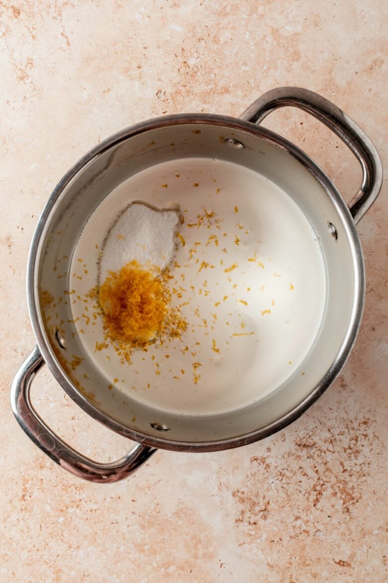 combining heavy cream, sugar, salt and lemon zest in pot