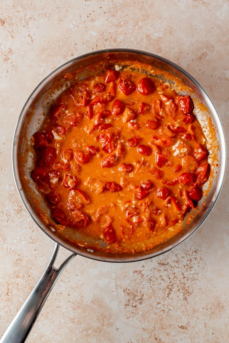stirring the burrata into the tomato sauce