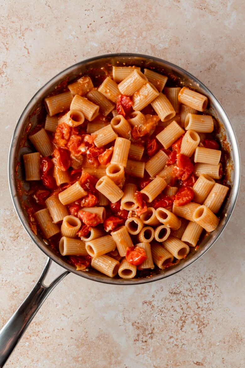 tossing pasta with the creamy tomato sauce