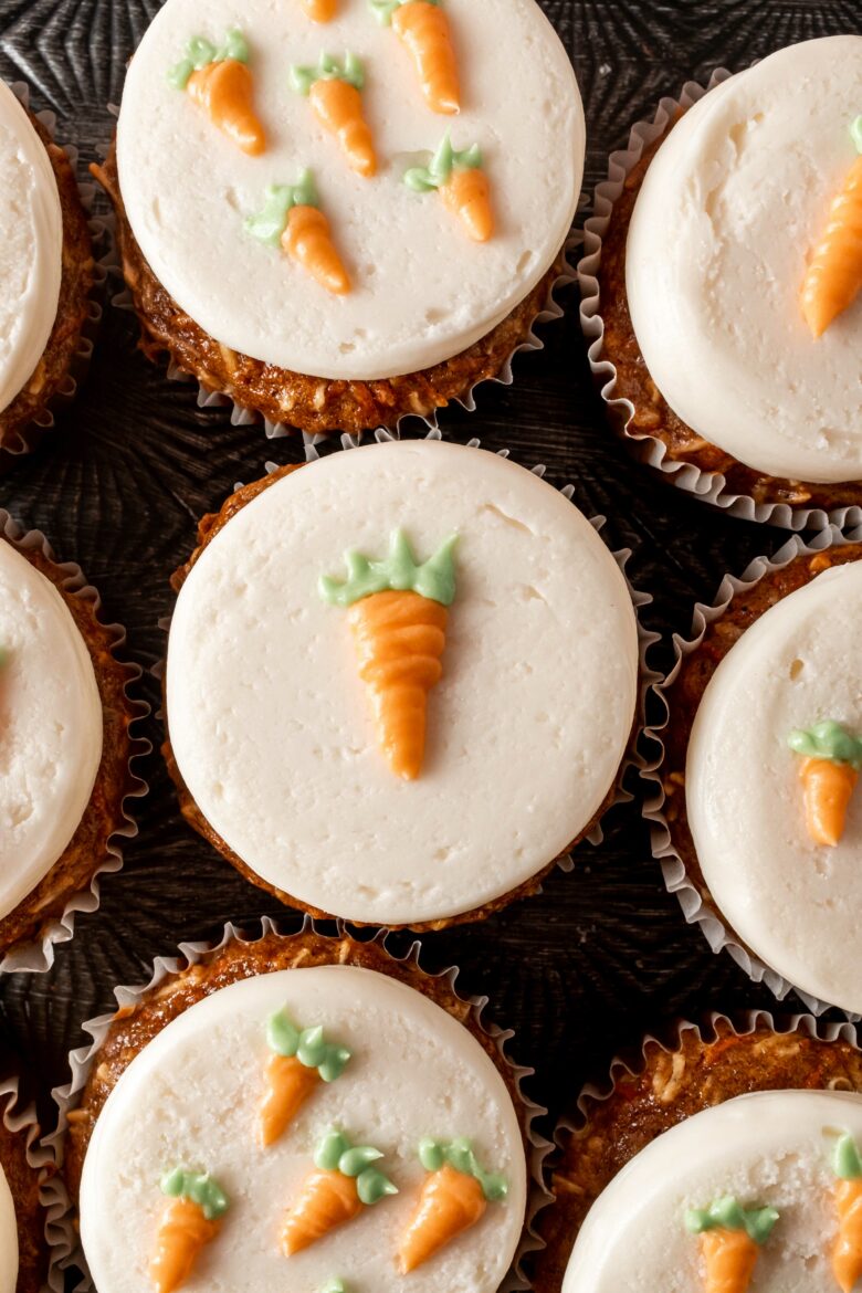 Cupcakes frosted and decorated with mini carrots