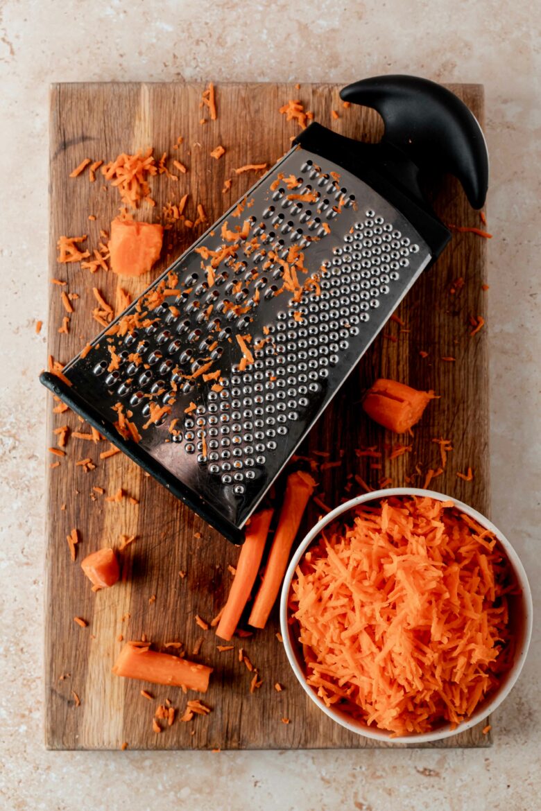 Shredding carrots on the small holes of a box grater