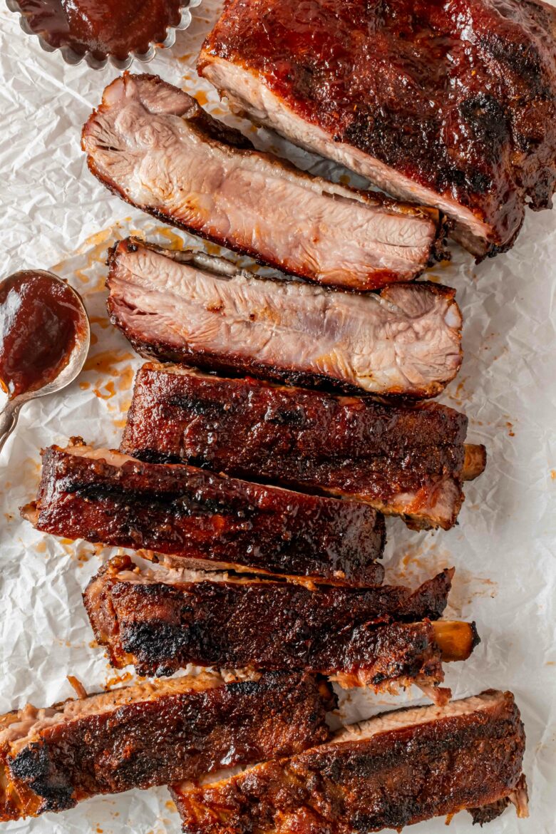 Entire slab of ribs covered with barbecue sauce and cut into pieces