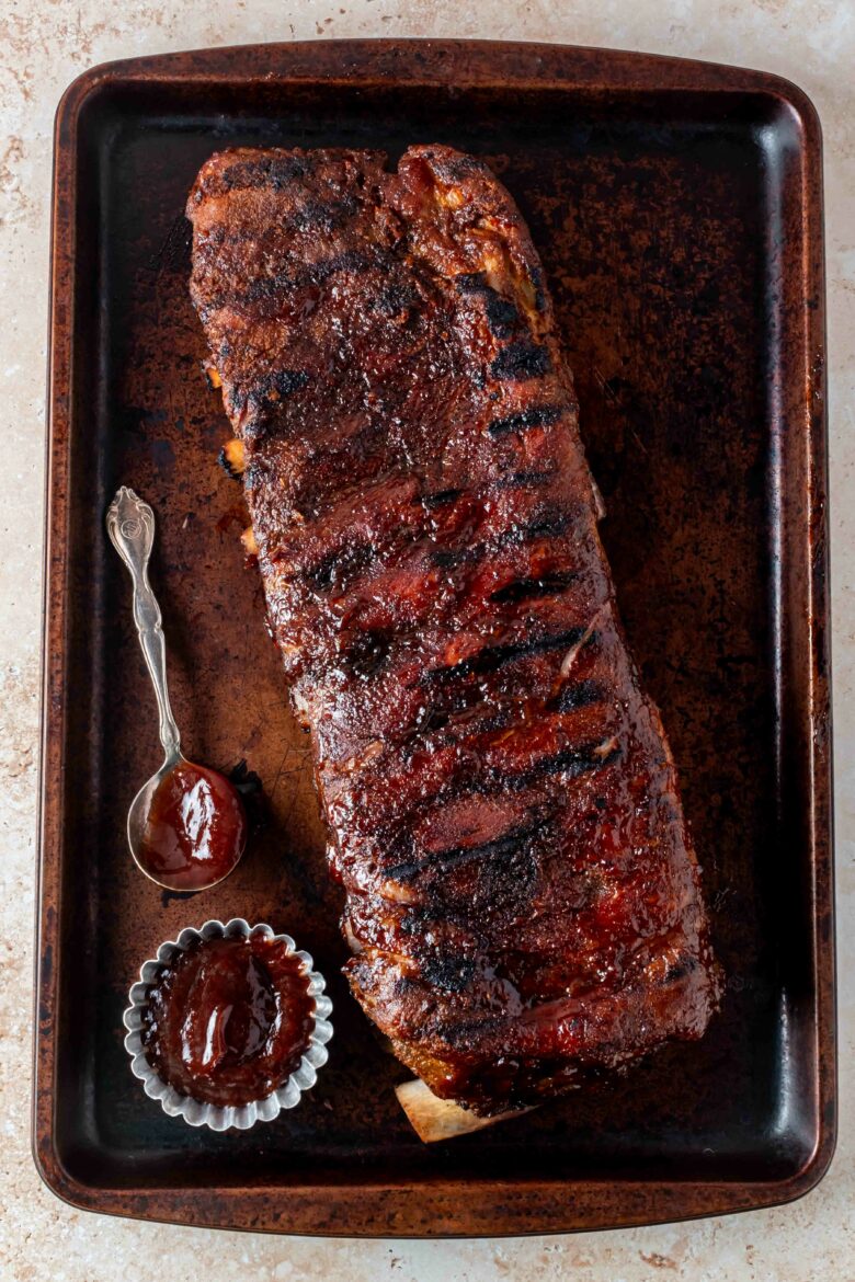 Slab of ribs slightly charred from grill