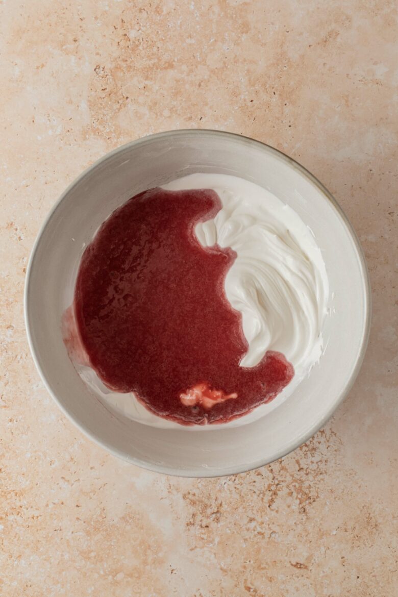mixing strawberry puree into whipped cream