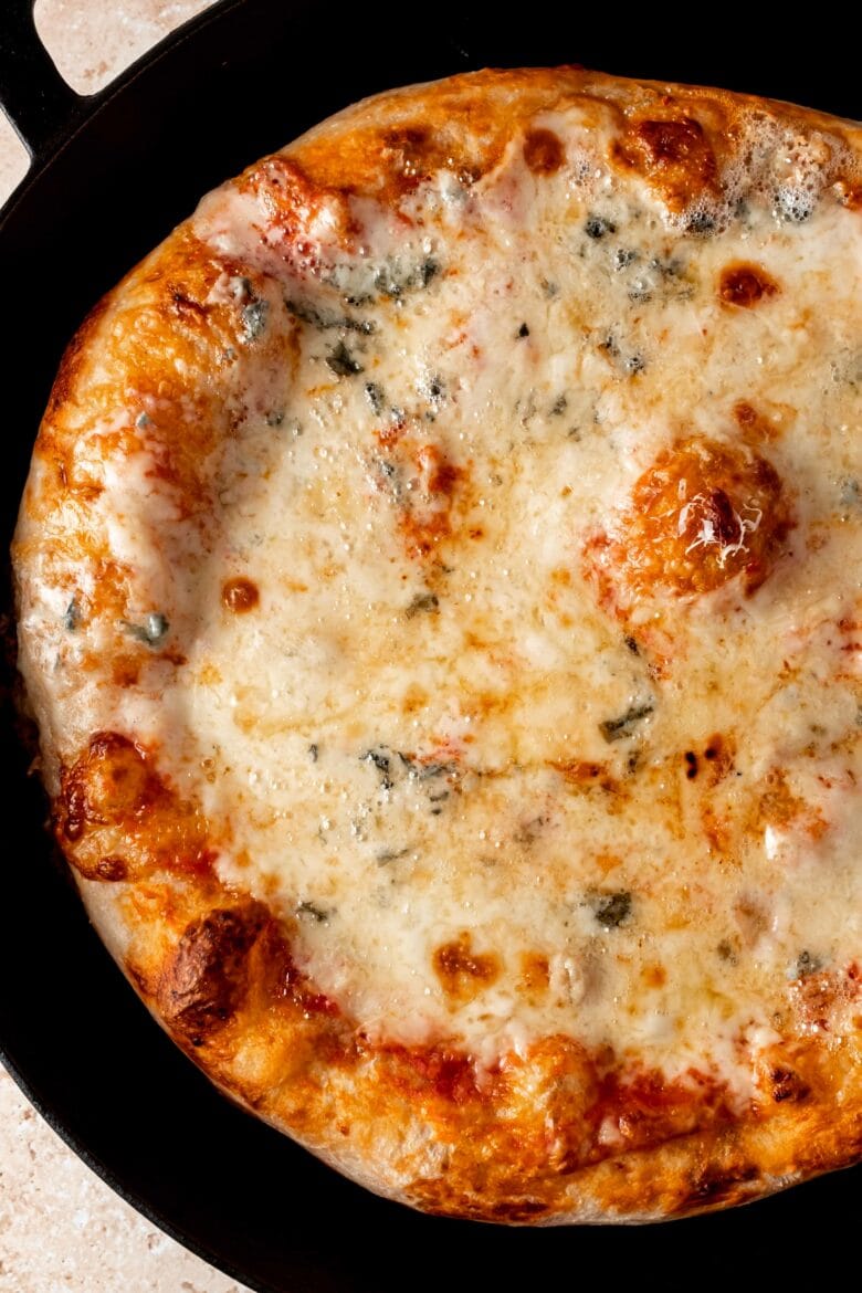 Quattro formaggi pizza in cast iron skillet