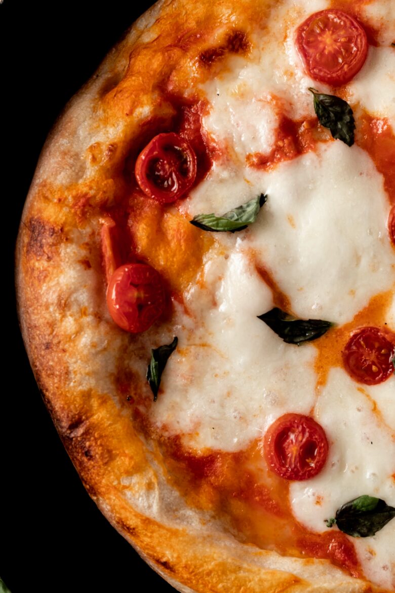 Close up of pizza margherita with cherry tomatoes and basil
