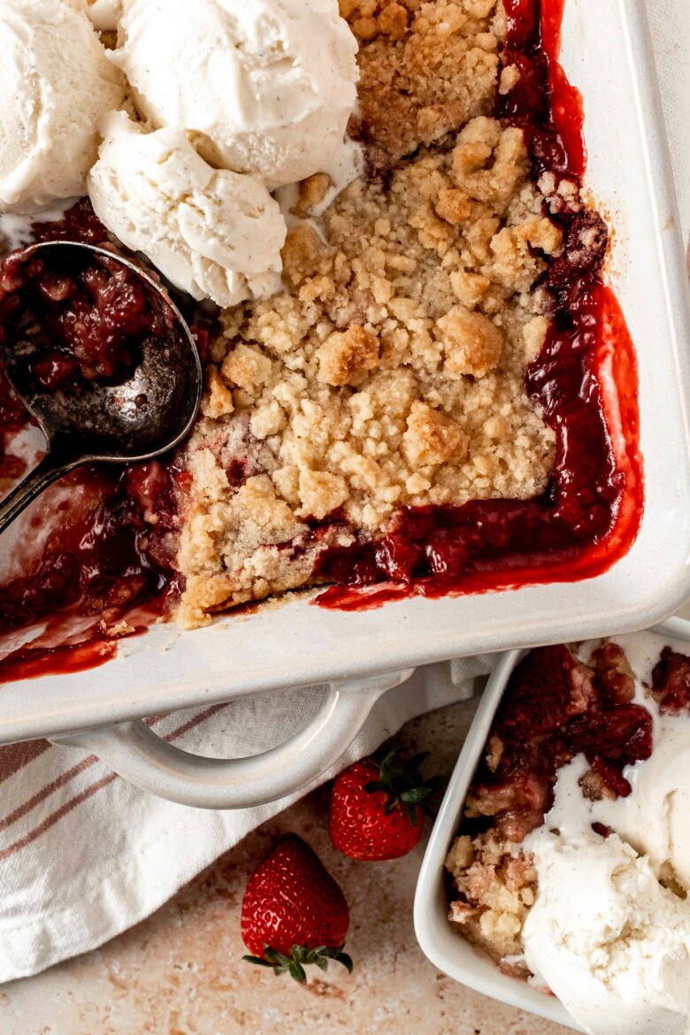 baking dish with strawberry crumble and ice cream