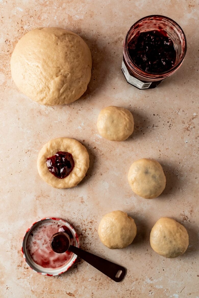 filling discs of dough with cherry preserves