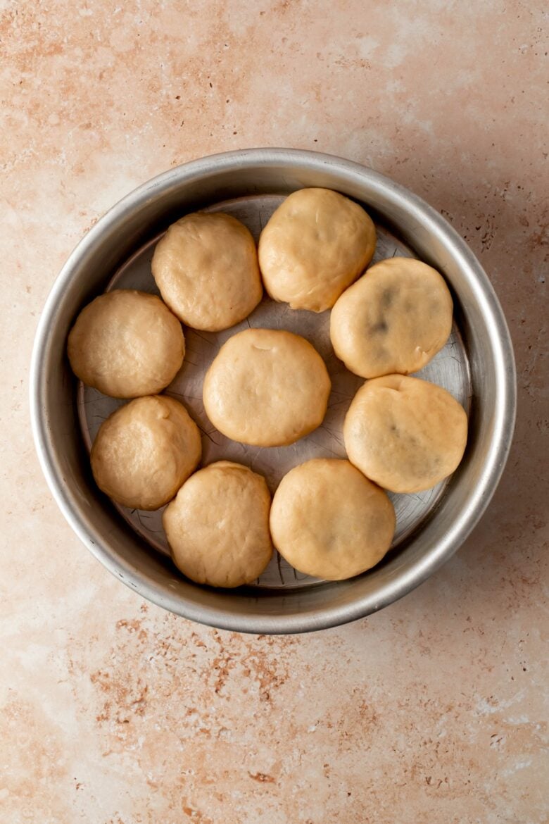 unbaked filled buns in round baking tin