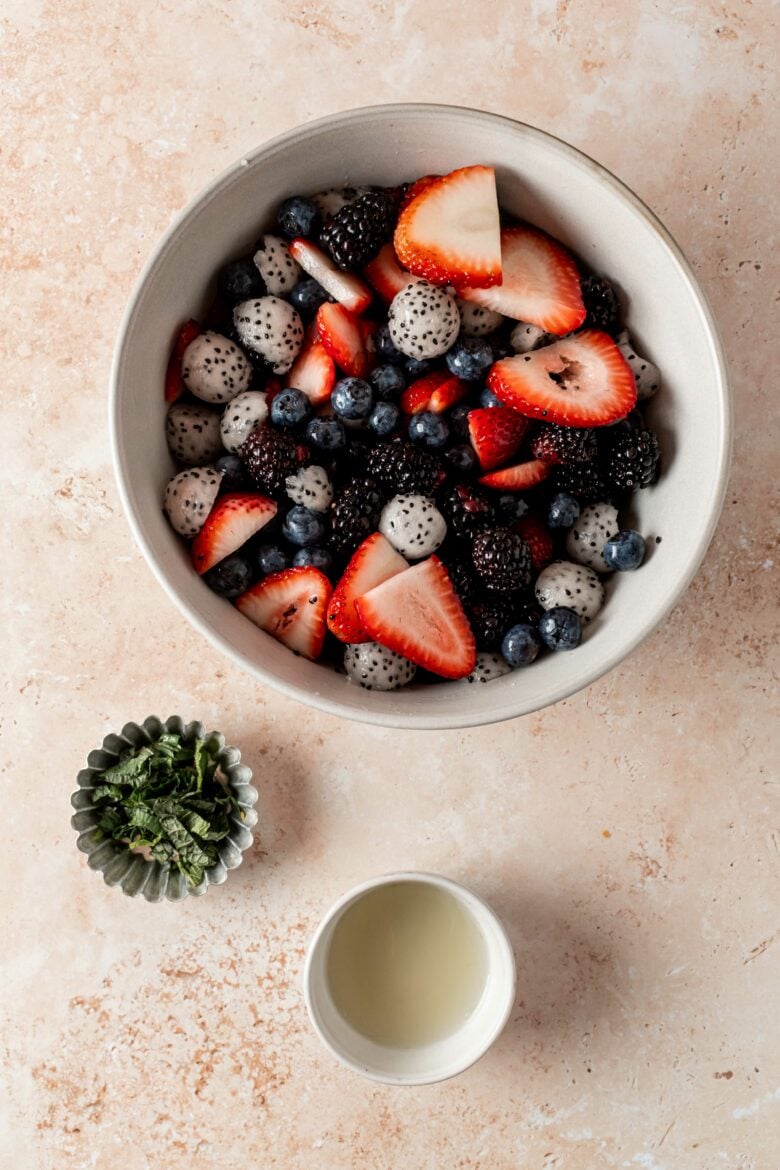 Preparing dressing with lime juice and chopped mint for fruit salad