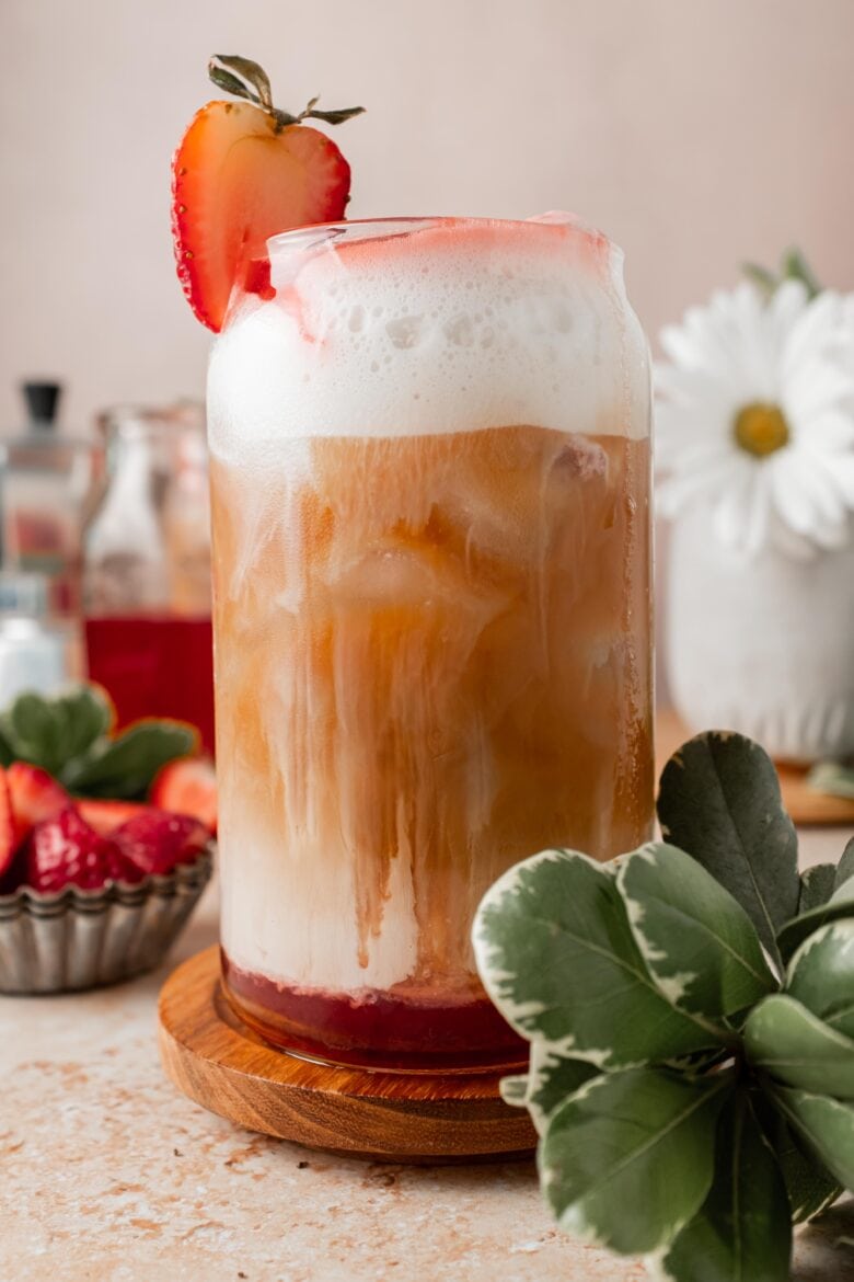 strawberry latte in a glass with cold frothed milk