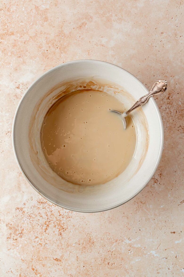 sweetened condensed milk mixed with vanilla extract in bowl