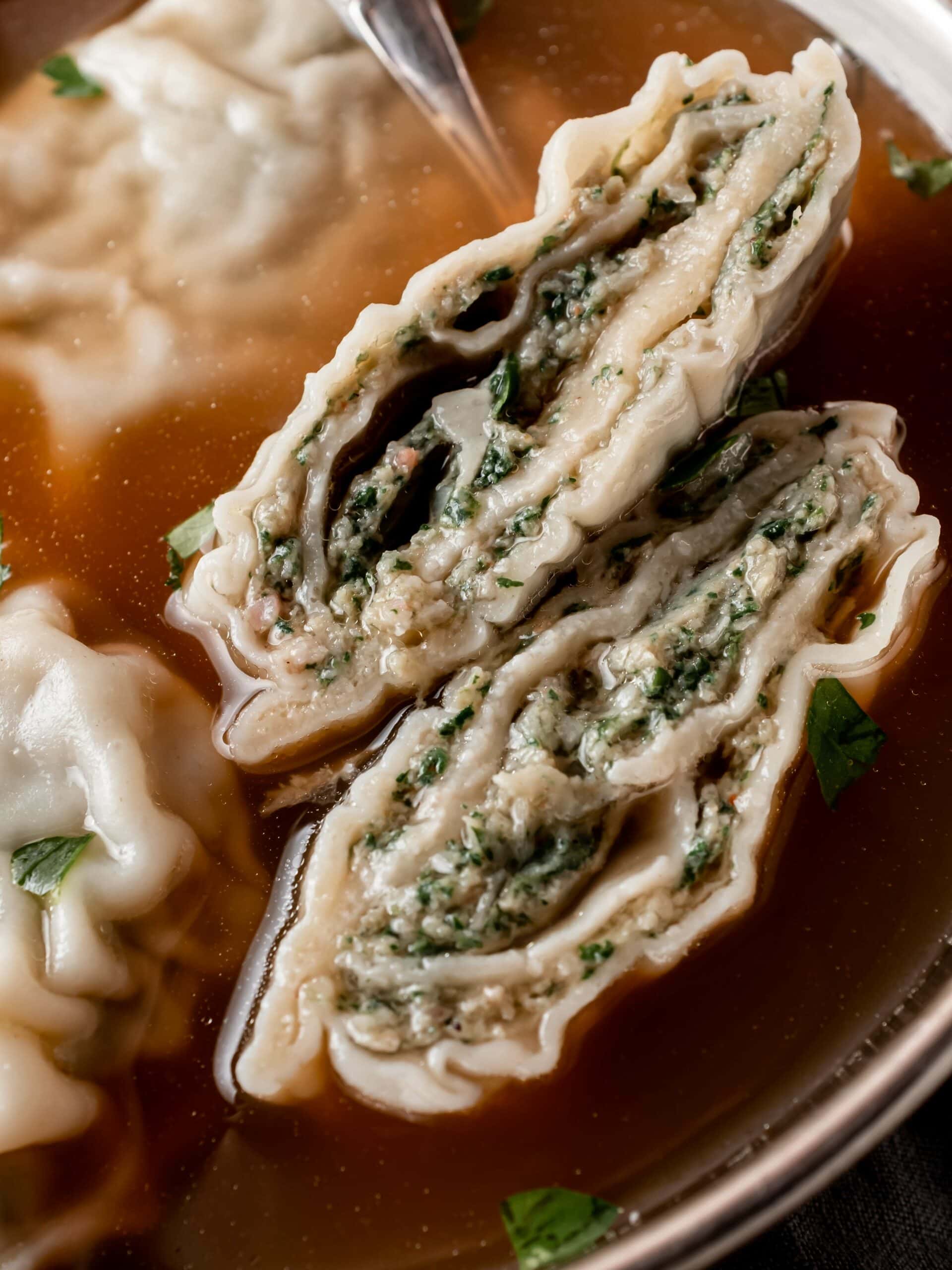 cross section of rolled maultaschen filled with spinach and meat