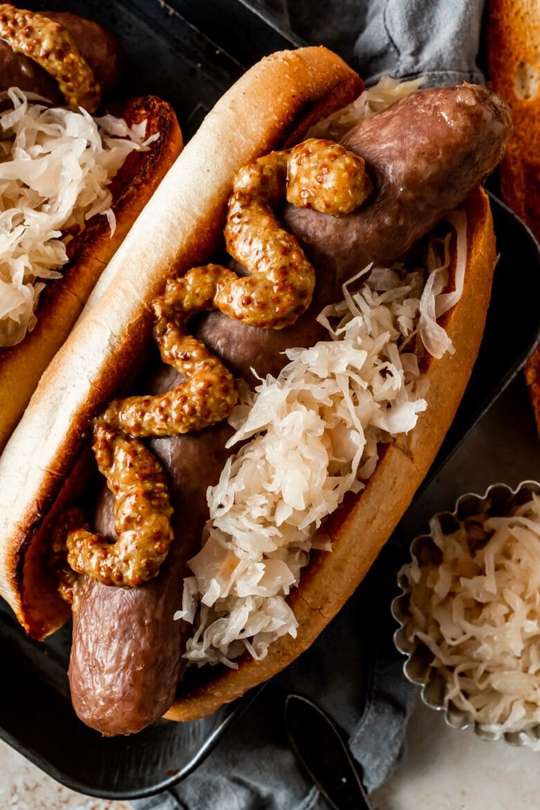 smoked sausage on a bun with sauerkraut and mustard