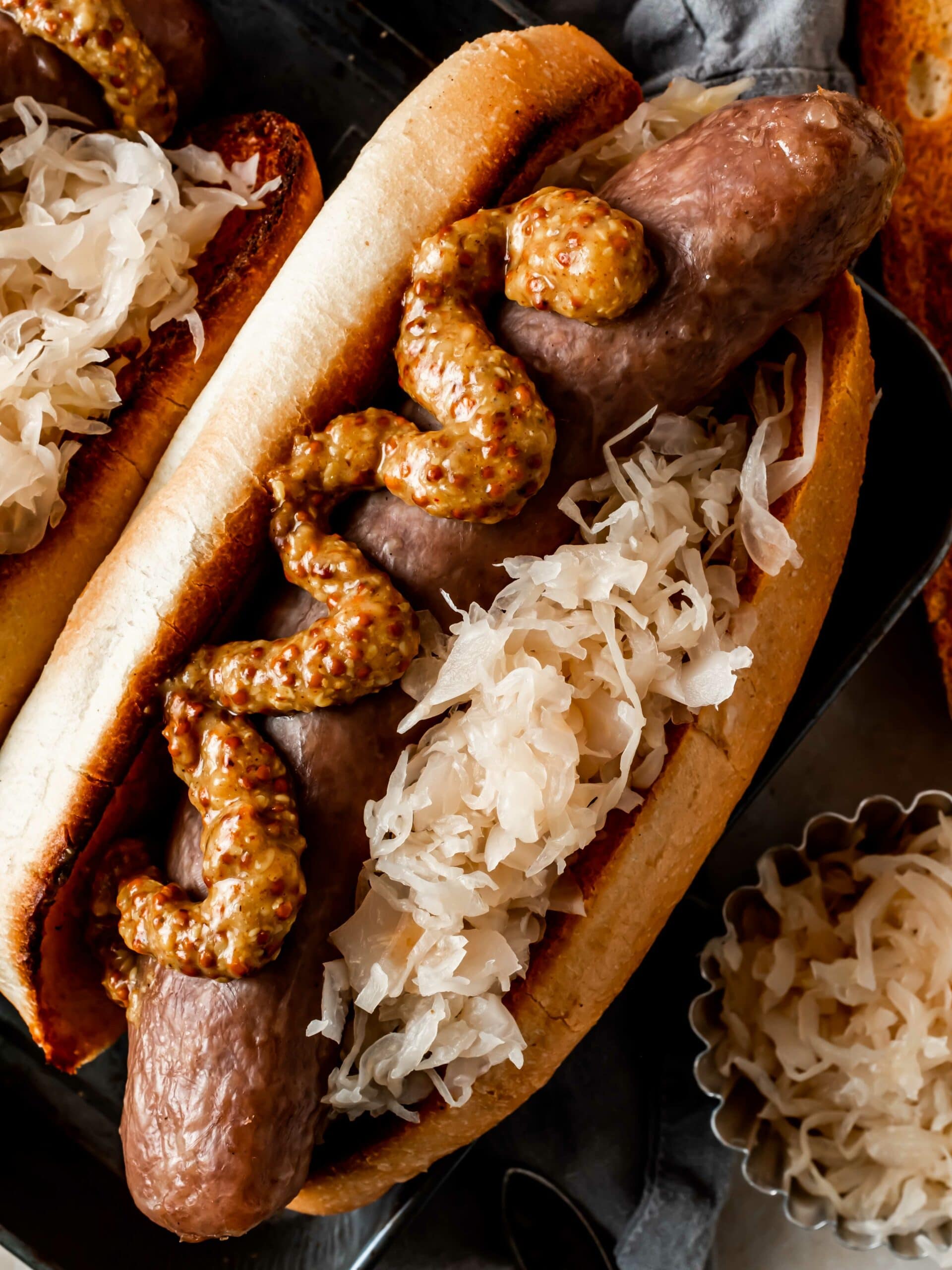 smoked sausage on a bun with sauerkraut and mustard