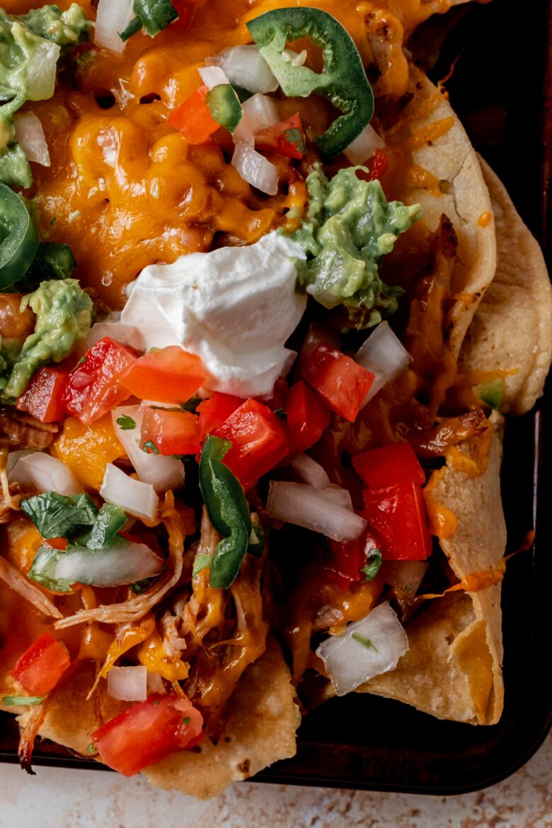 Nachos on sheet pan with toppings