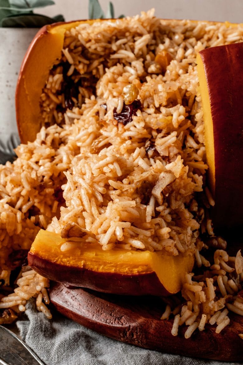 Whole pumpkin cut so rice stuffing is spilling out.