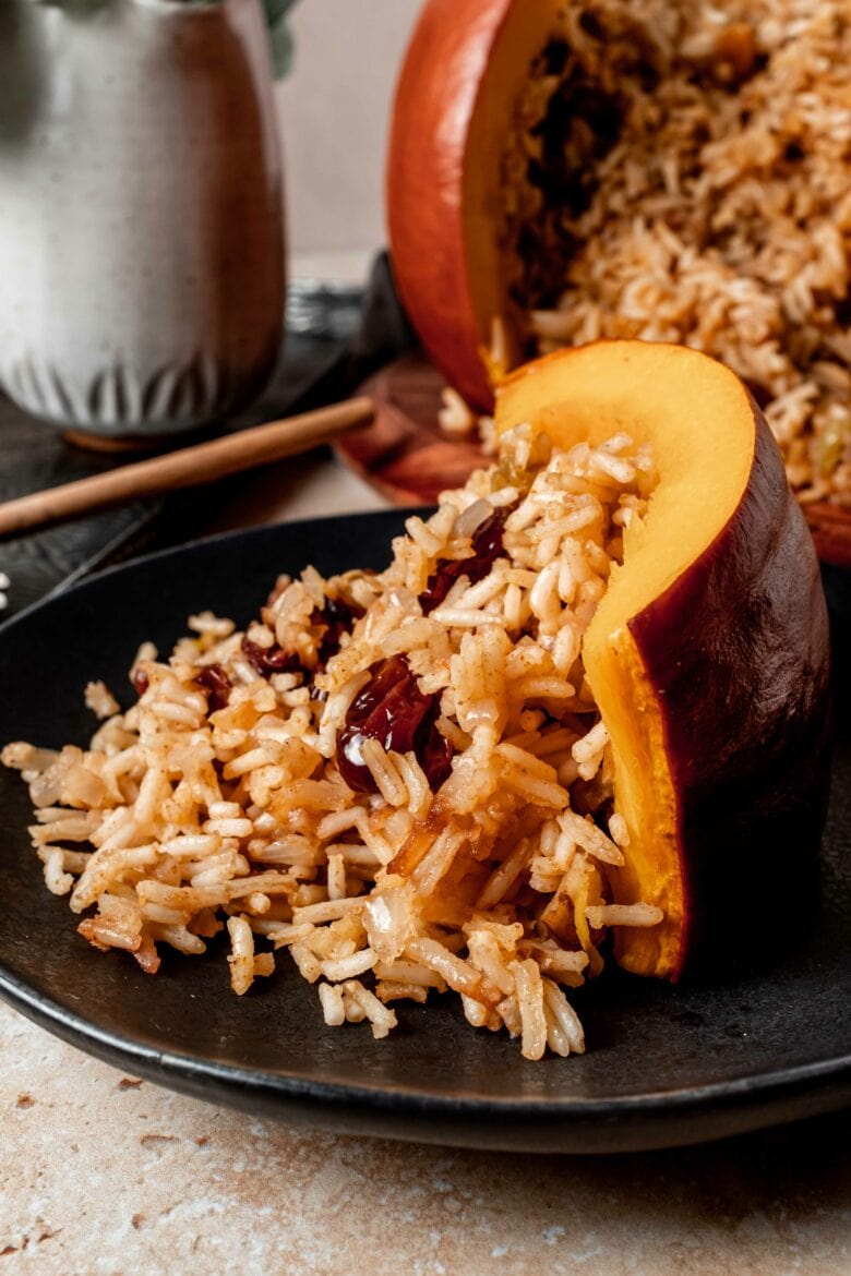 Piece of pumpkin on plate with rice.