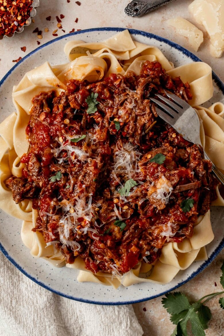 Short rib ragu over pappardelle noodles with parmesan and red pepper flakes.