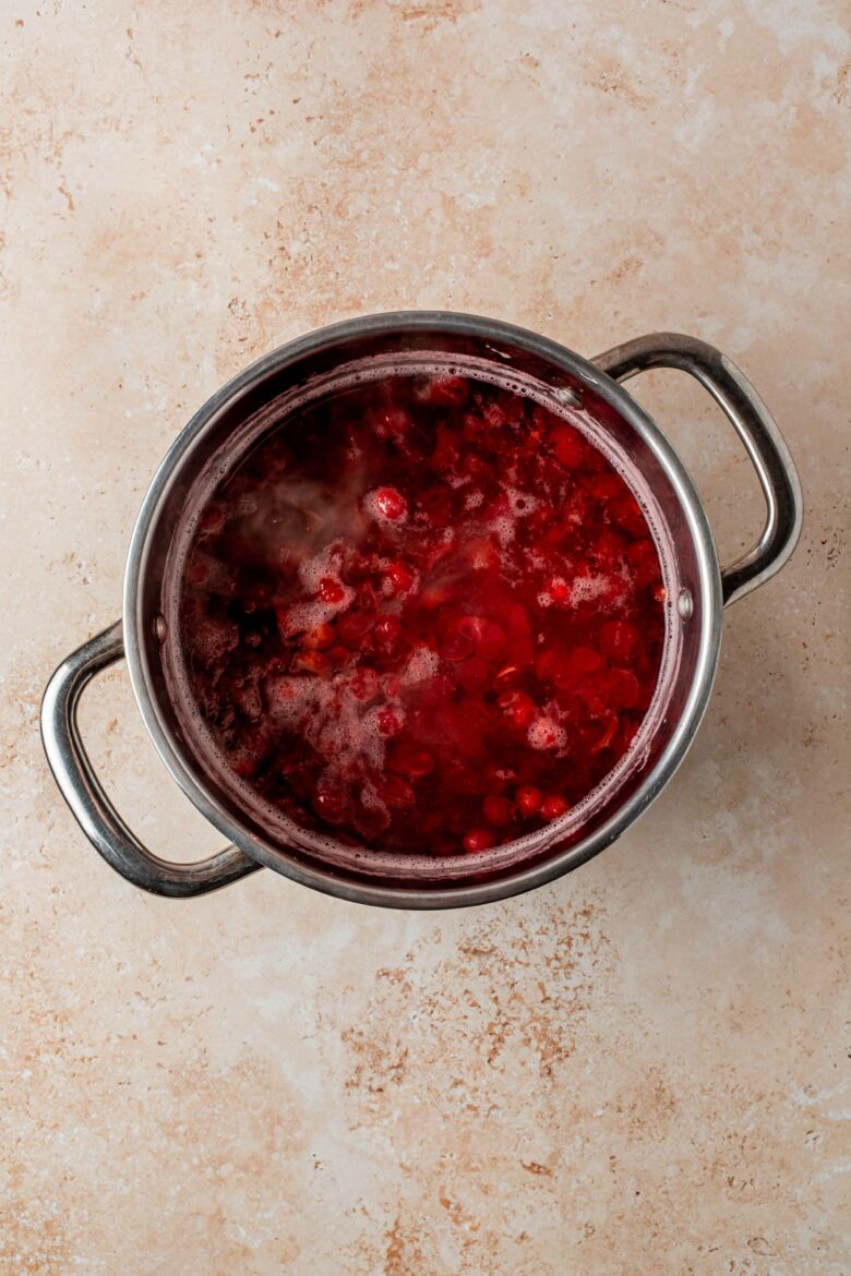 Burst cranberries in saucepan.