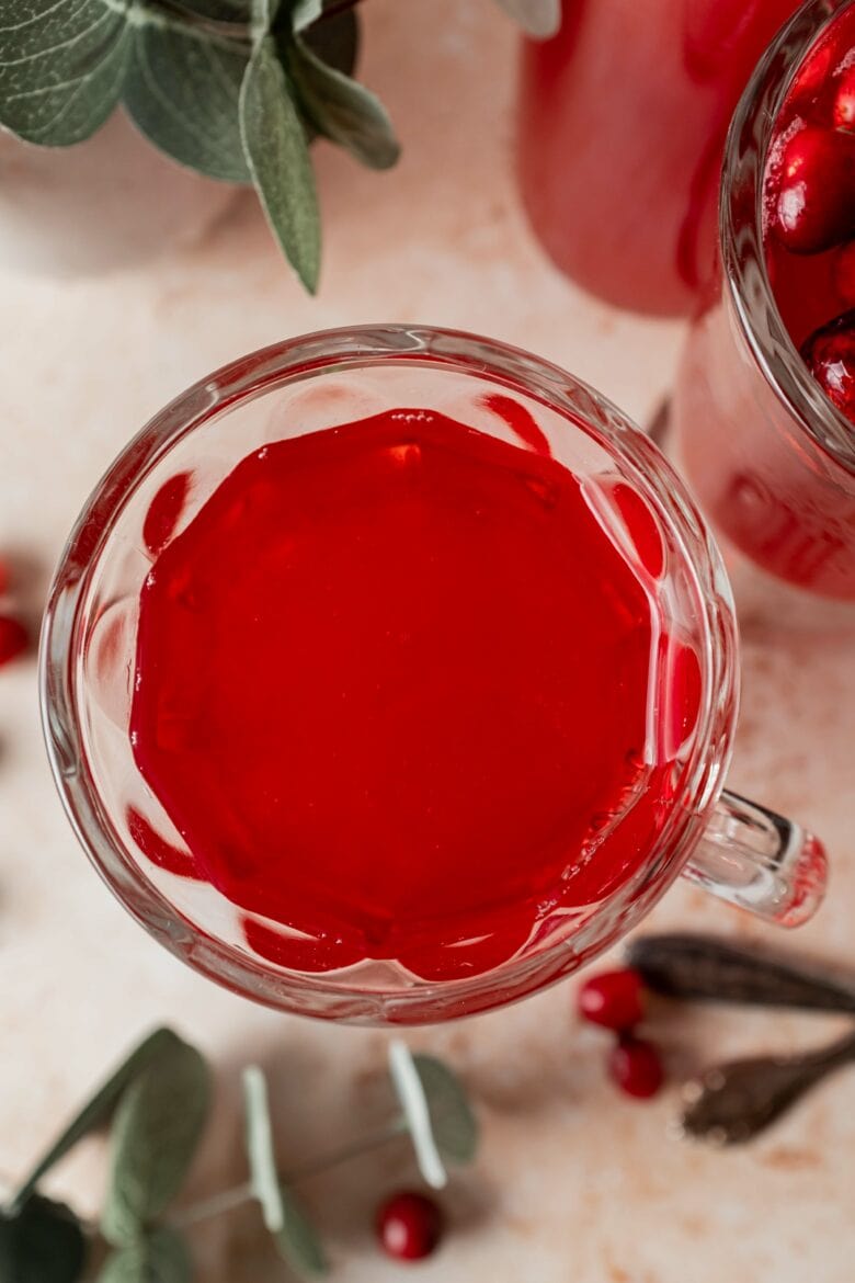 Overhead view of cranberry juice in glass.
