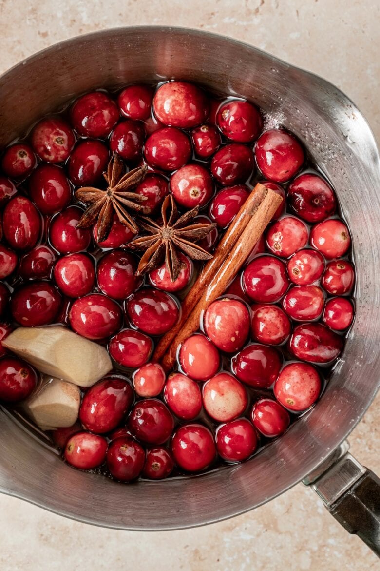 Cranberries, cinnamon, star anise and ginger in sugar and water before simmering.