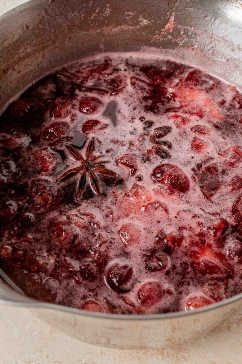 Spiced cranberry simple syrup in pot before straining.
