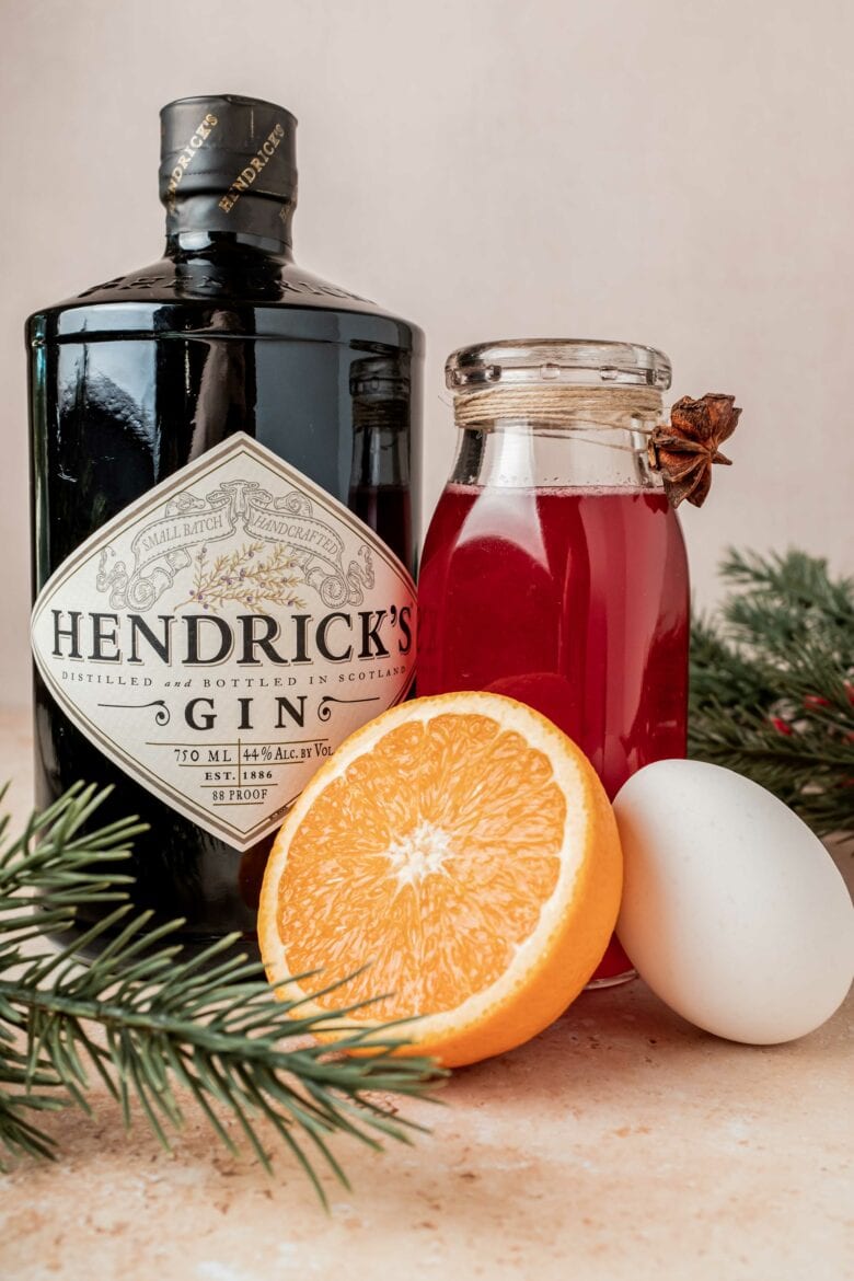 Hendrick's gin, cranberry simple syrup, orange and egg ready to make gin fizz.