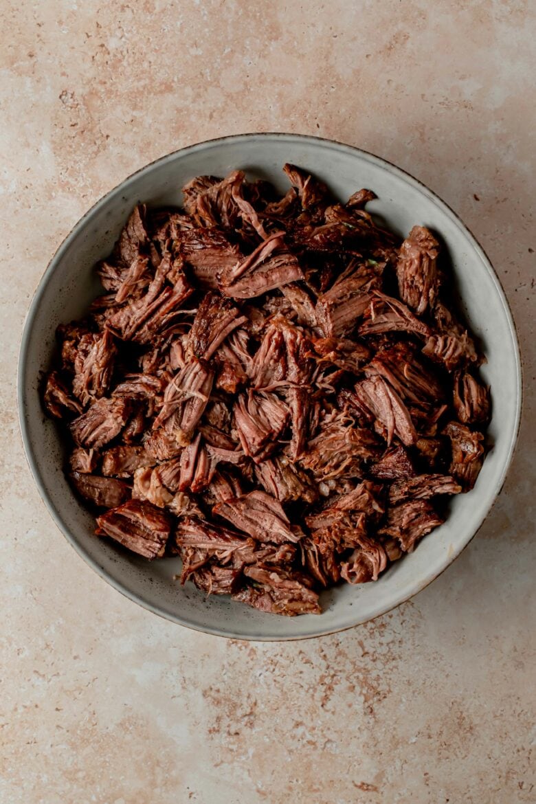 Shredded barbacoa beef on platter.