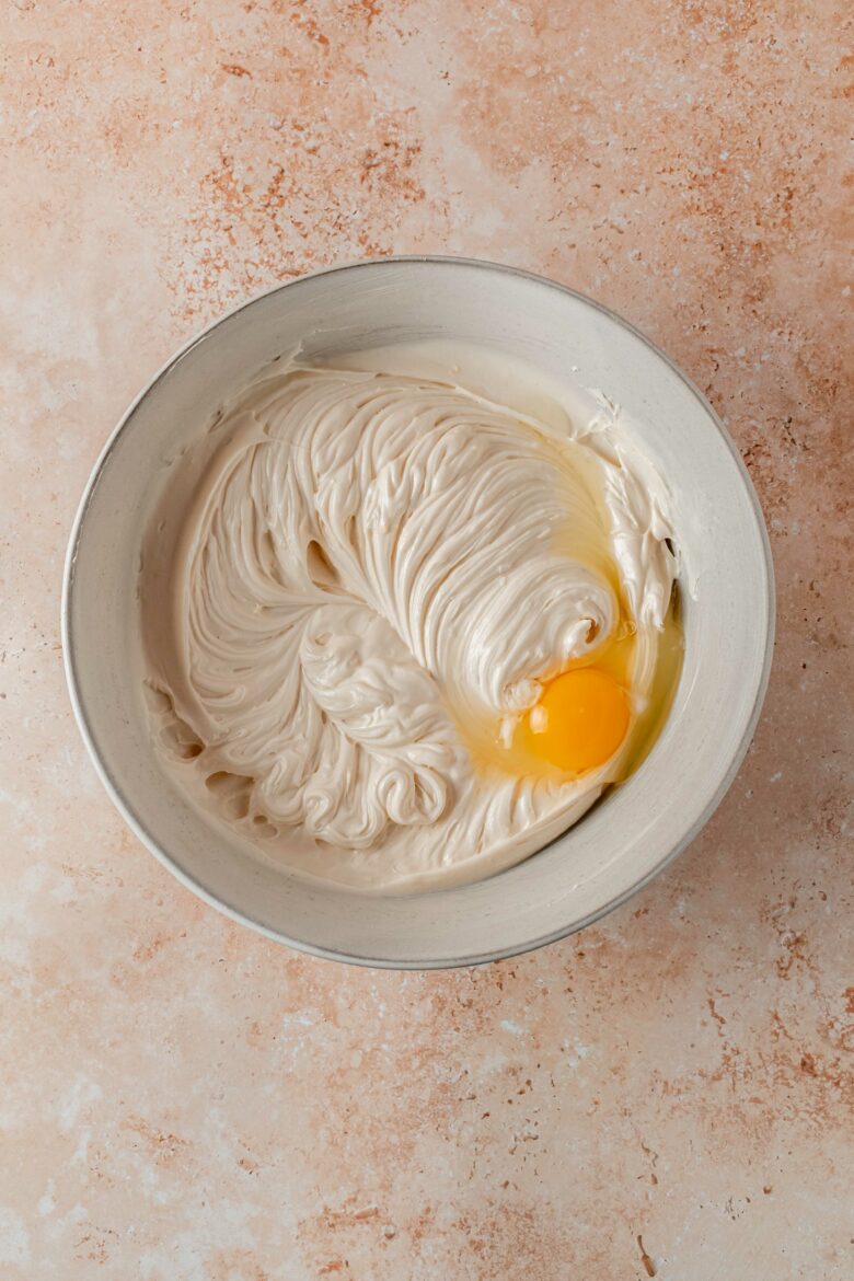 Mixing egg into batter.