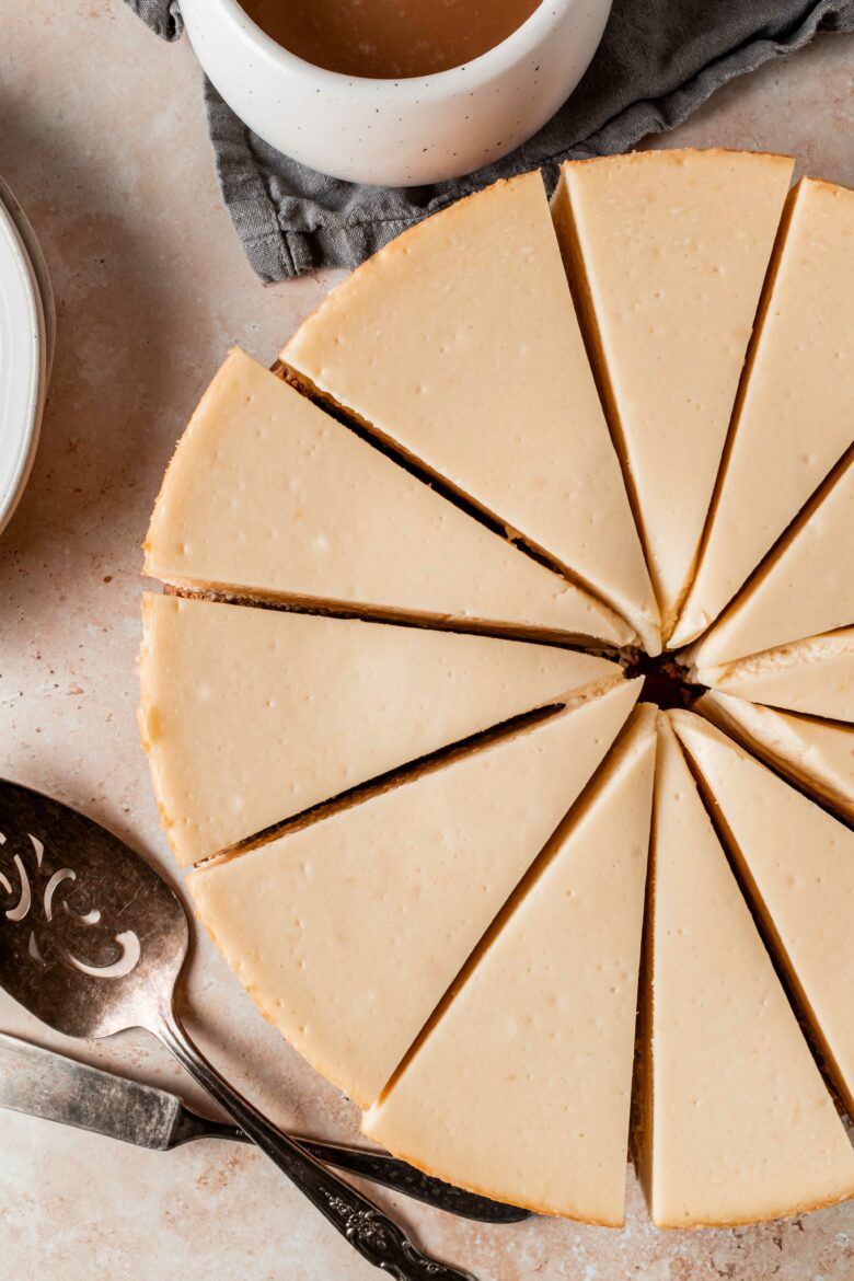 Overhead view of cheesecake cut into slices.