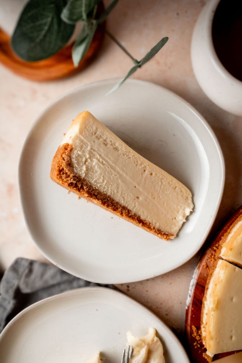 Slice of creamy New York cheesecake on a plate.