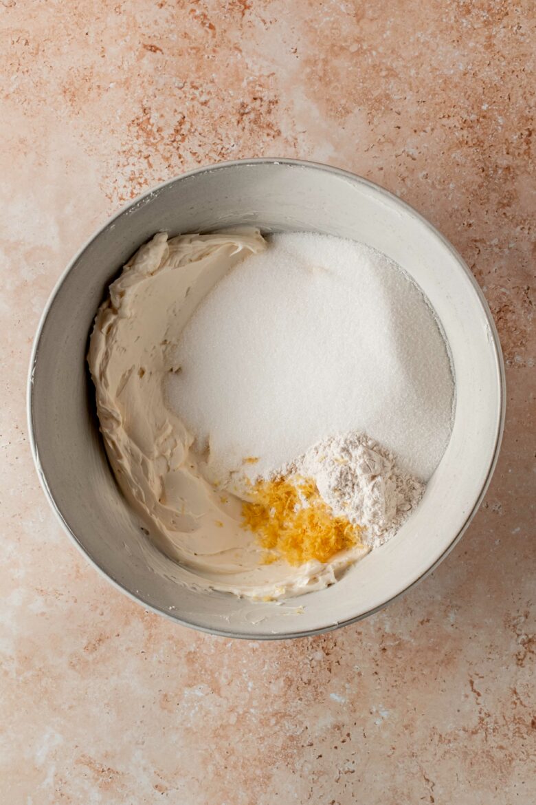 Creaming cream cheese with sugar, flour and lemon zest.