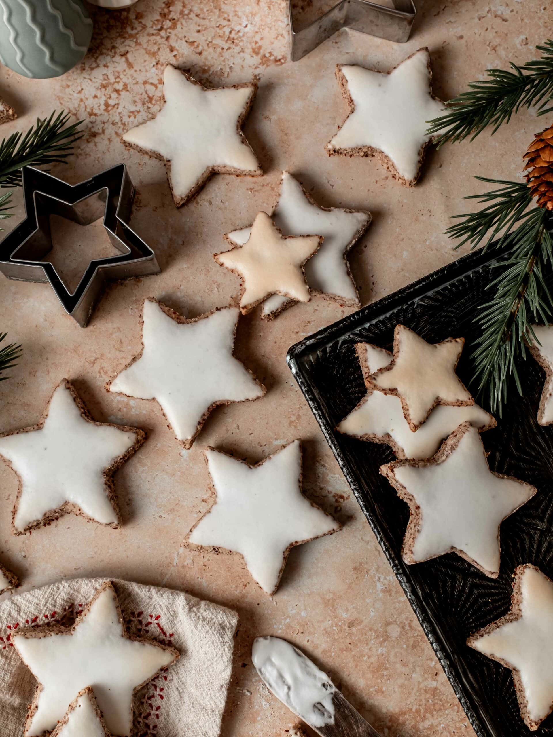 Frosted and baked Zimtsterne cookies.