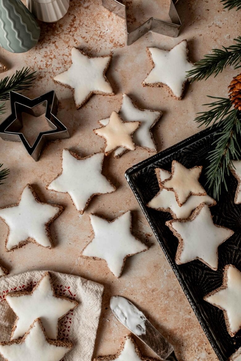 Frosted and baked Zimtsterne cookies.