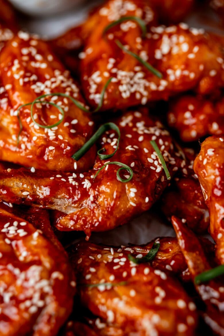 Close up of crispy wings in spicy Gochujang sauce.