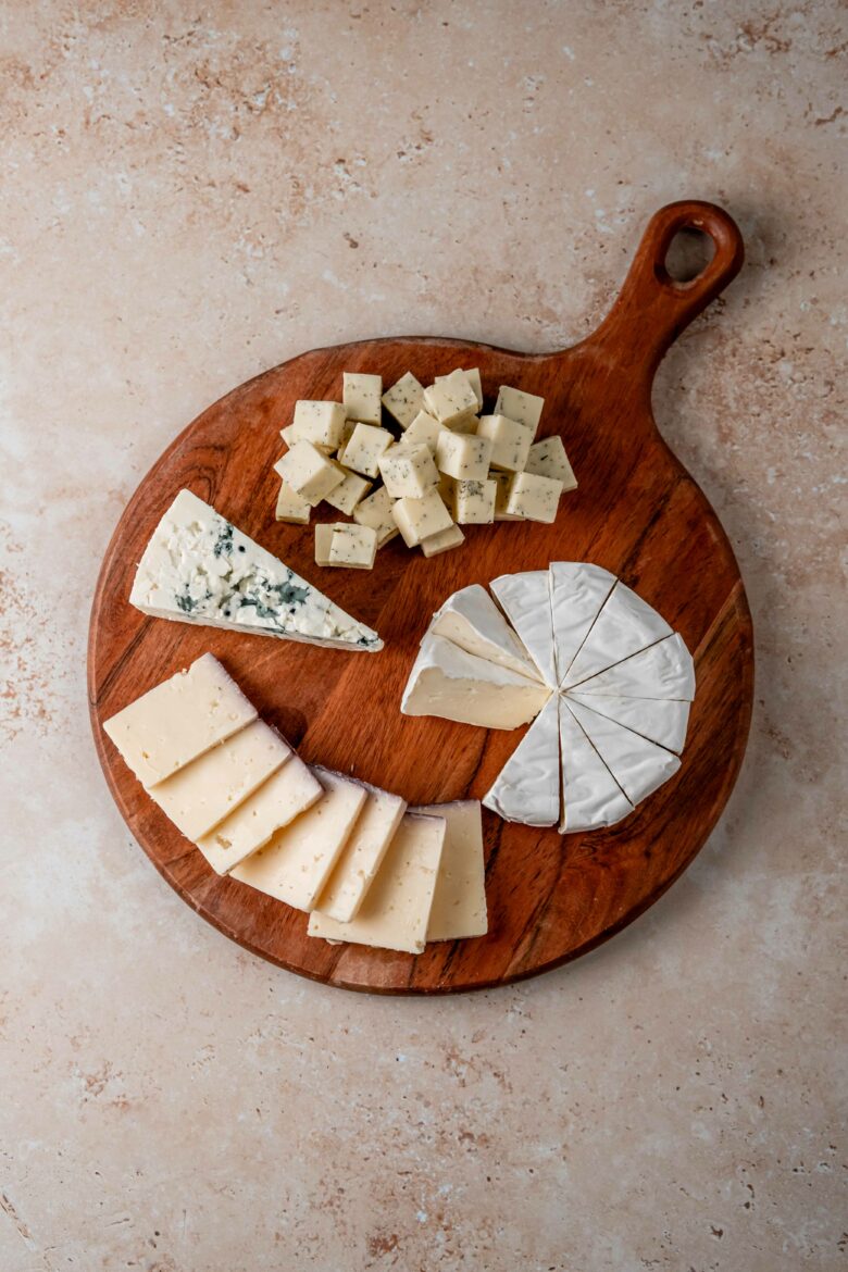 Slicing the cheese into a variety of shapes.