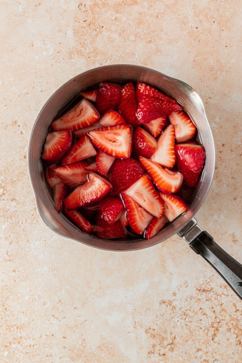 quartered strawberries in small saucepan