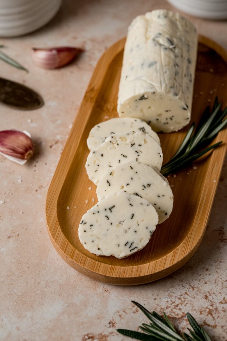 Log of garlic rosemary butter cut into slices.