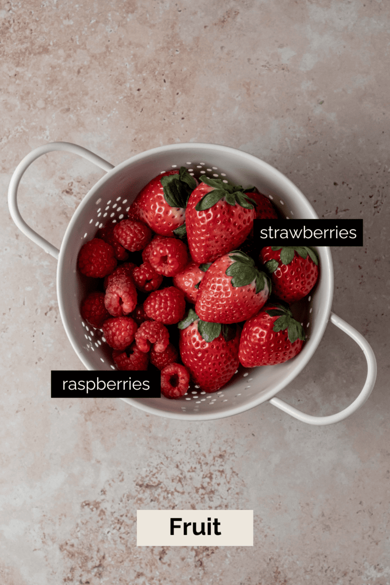 Strawberries and raspberries in colander.