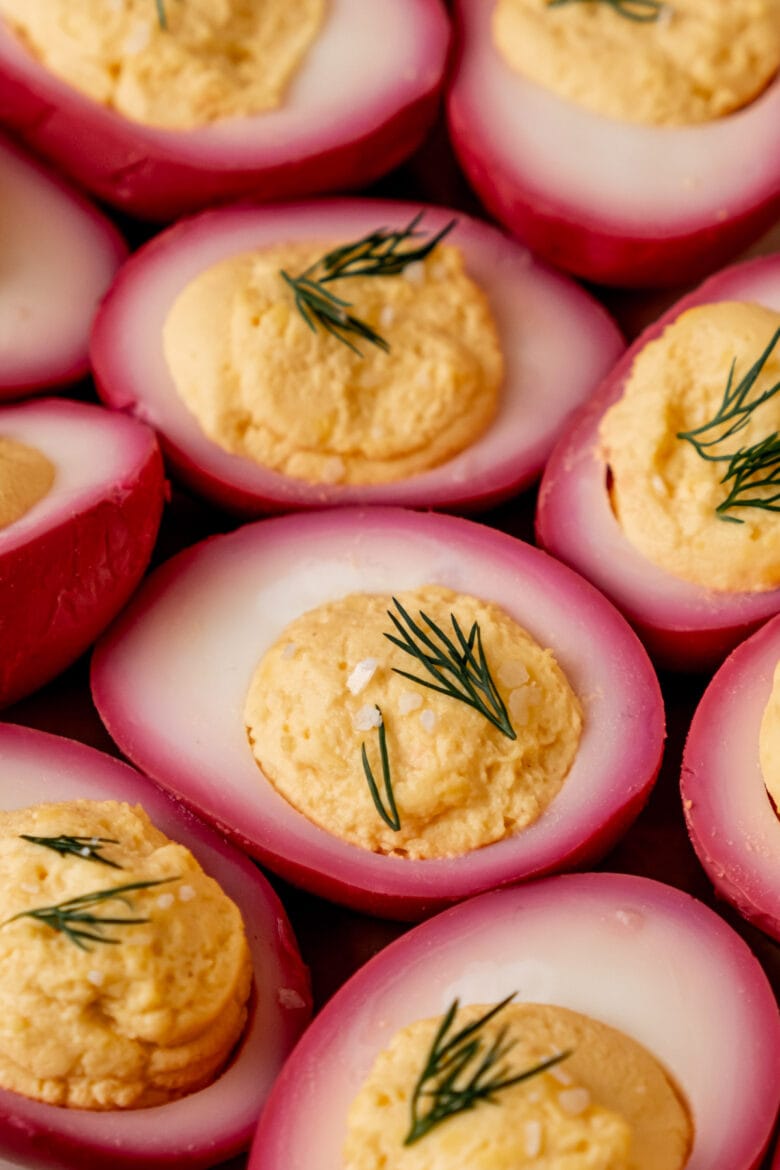 Naturally colored deviled eggs with pink hue from beet pickling.