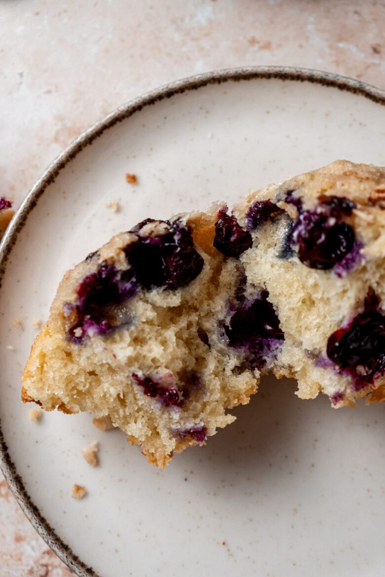 Blueberry muffin cut in half showing soft crumb and tender blueberries.