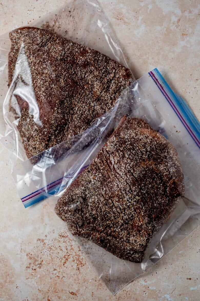 Corned beef coated in spices and placed in zip-top bag.