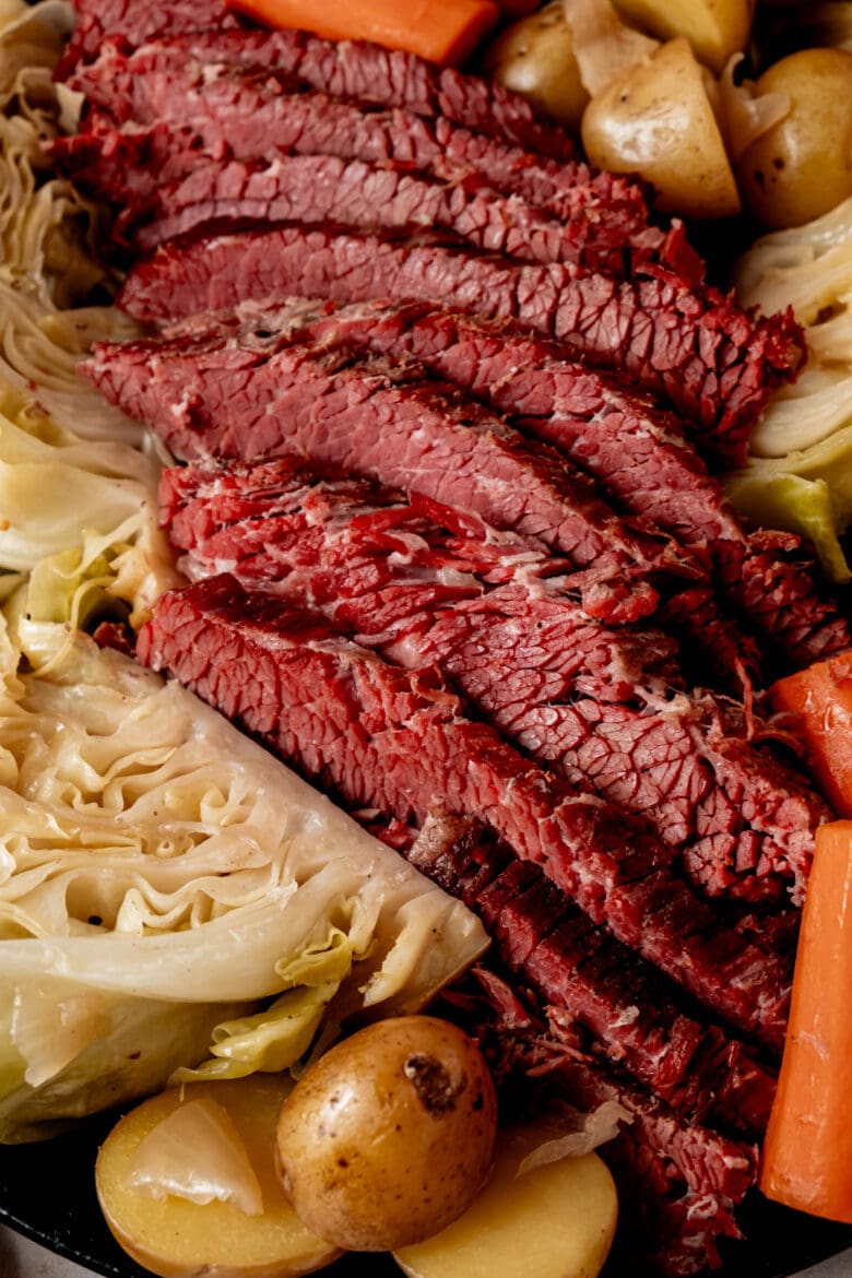 Sliced corned beef with cabbage and potatoes.