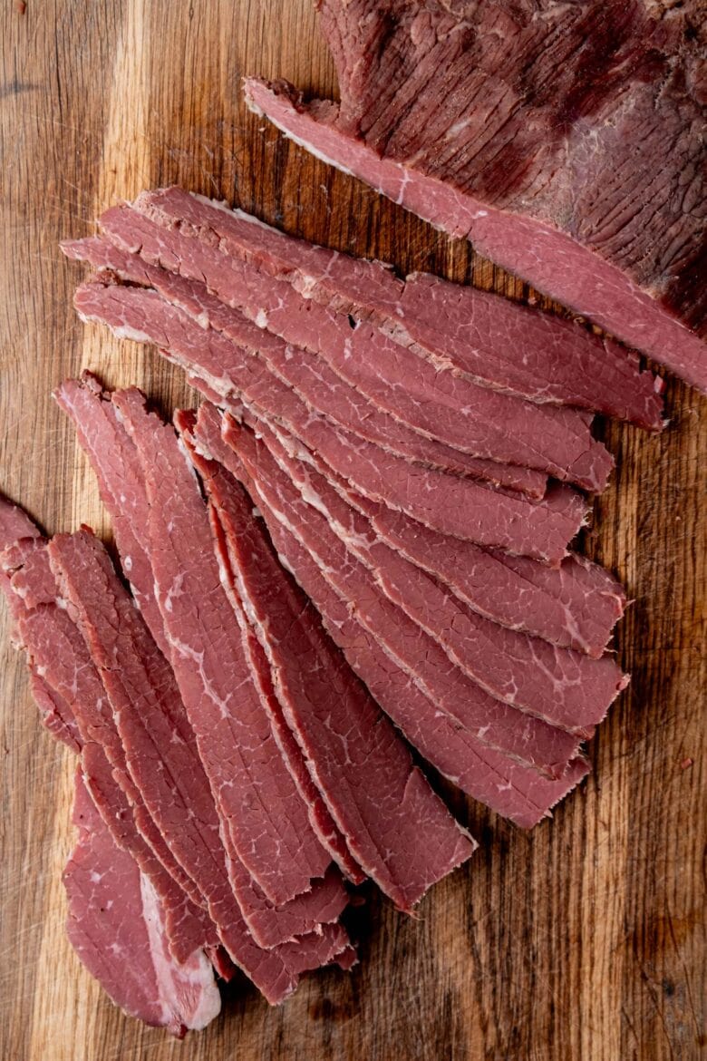 Slicing corned beef while cold to get thin slices.