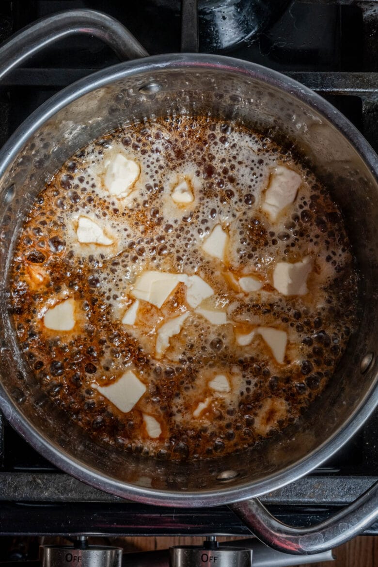 Adding butter to hot caramel mixture.