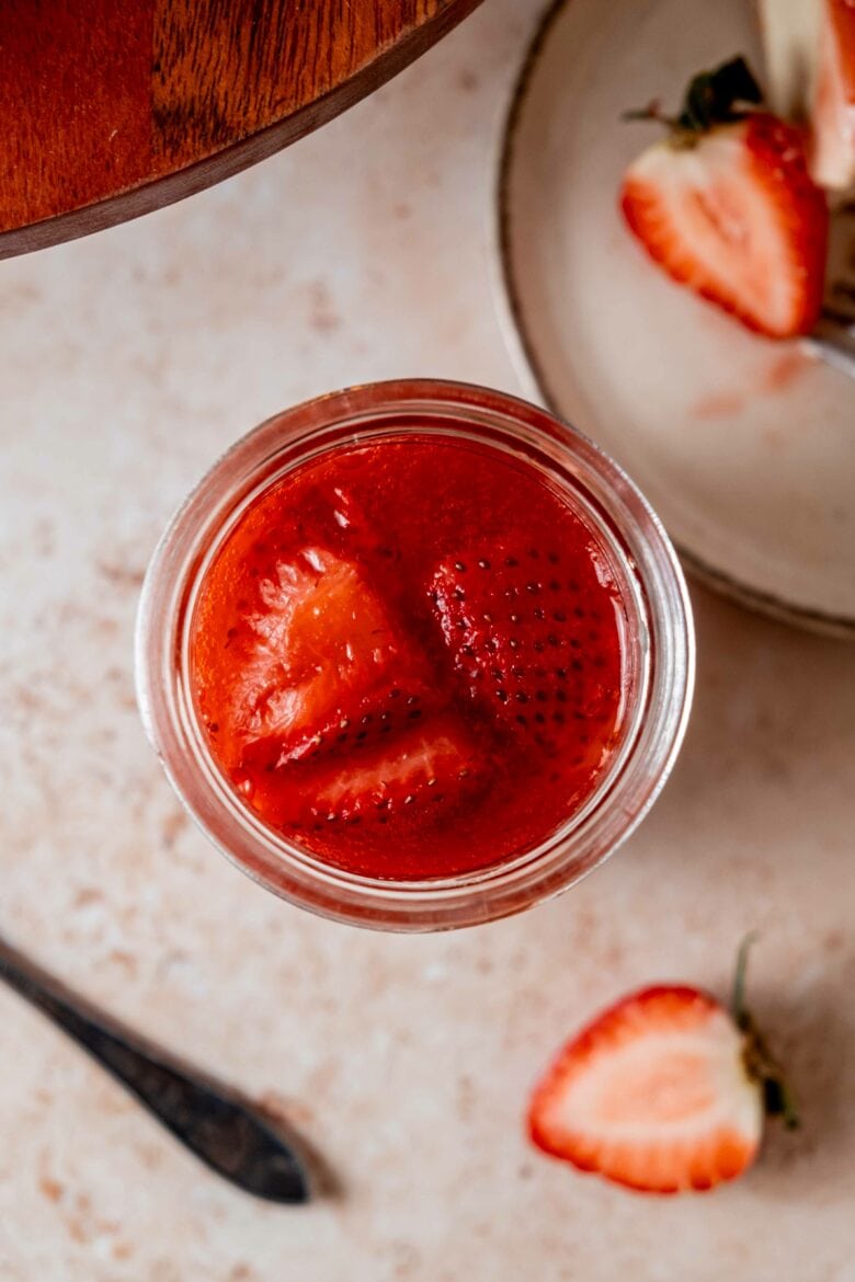 Overhead view of strawberry sauce in jar.